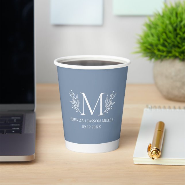White monogram botanical flower on blue-grey paper cups (Insitu)