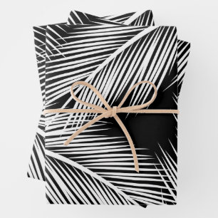 White palm leaves on black colour background wrapping paper sheet