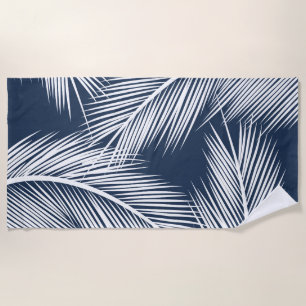 White palm leaves on dark blue colour background beach towel