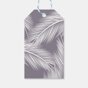 White palm leaves on purple colour background gift tags