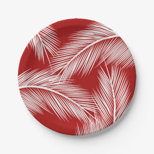 White palm leaves on red colour background paper plate