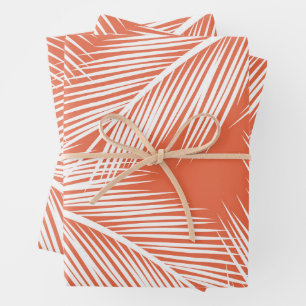 White palm leaves on salmon colour background wrapping paper sheet