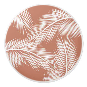 White palm leaves on terracotta colour background ceramic knob