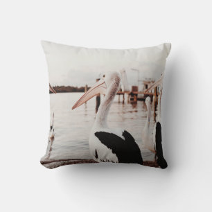 WHITE PELICAN ON BODY OF WATER DURING DAYTIME CUSHION