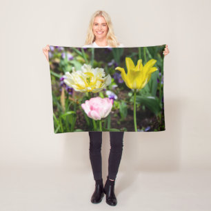 White, pink and yellow tulips in the garden   fleece blanket