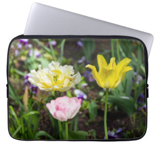 White, pink and yellow tulips in the garden laptop sleeve