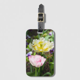 White, pink and yellow tulips in the garden     luggage tag
