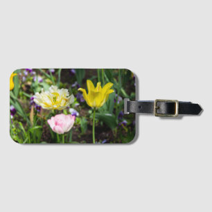White, pink and yellow tulips in the garden luggage tag