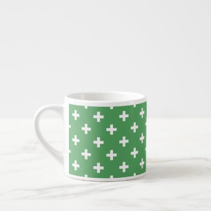 White polka crosses on green espresso cup