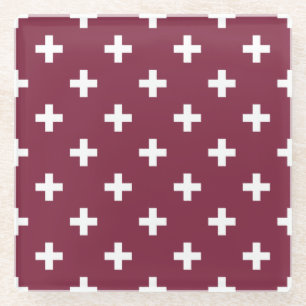 White polka crosses on mulberry glass coaster