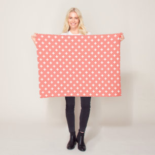 White polka crosses on peach fleece blanket