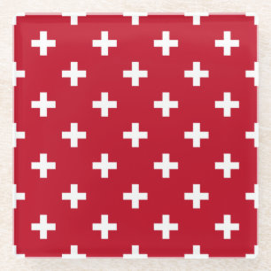 White polka crosses on red glass coaster