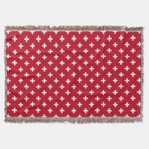White polka crosses on red throw blanket