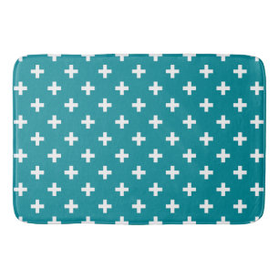 White polka crosses on teal bath mat