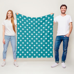 White polka crosses on teal fleece blanket