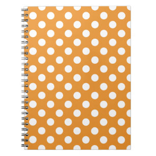 White polka dots on amber notebook