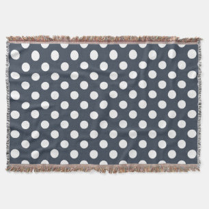 White polka dots on blue-grey throw blanket