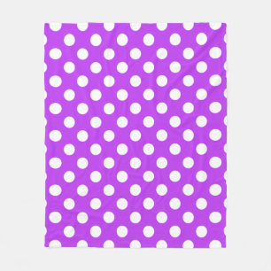White polka dots on bright purple fleece blanket