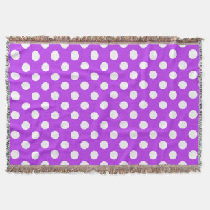 White polka dots on bright purple throw blanket