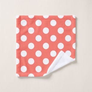 White polka dots on living coral wash cloth