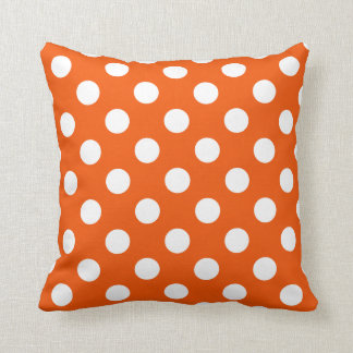 White polka dots on orange cushion