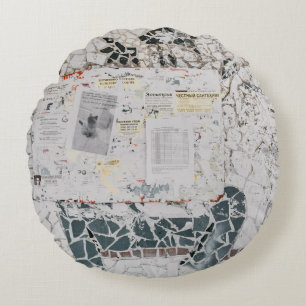 White printer paper on white and grey concrete wal round cushion