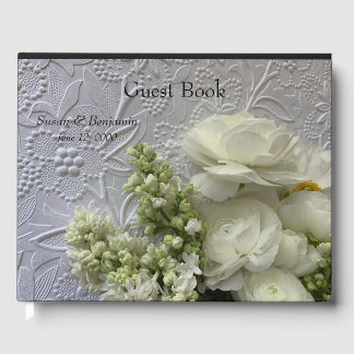 White ranunculus and lilacs on textured paper guest book