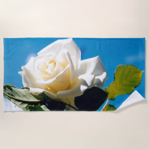 White rose under blue sky beach towel