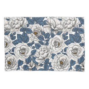 White roses with blue leaves on white pillowcase
