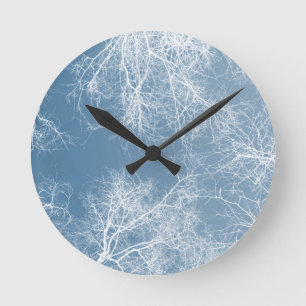 White silhouetted trees round clock