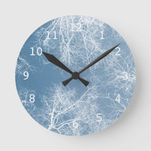 White silhouetted trees round clock