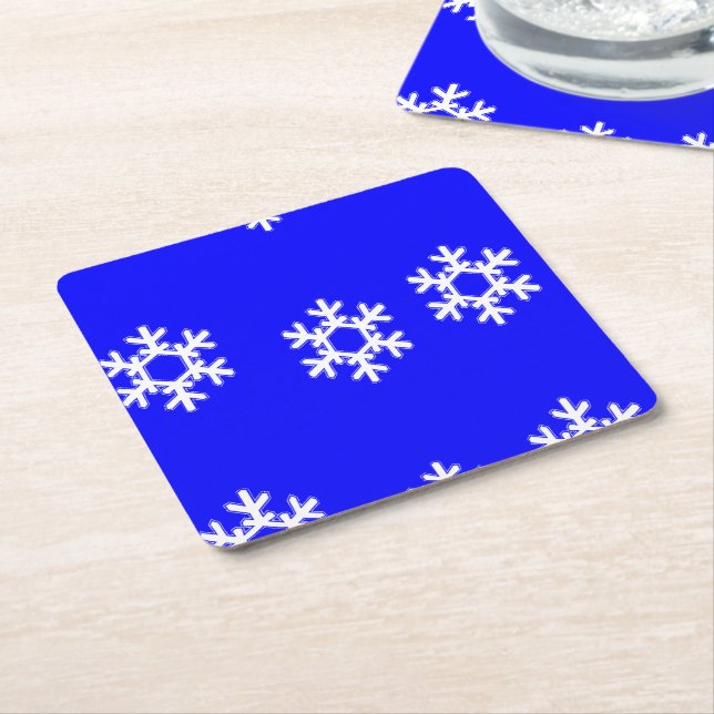 White snowflakes on blue square paper coaster (Angled)