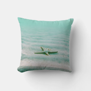 White starfish on sand underwater in the morning cushion