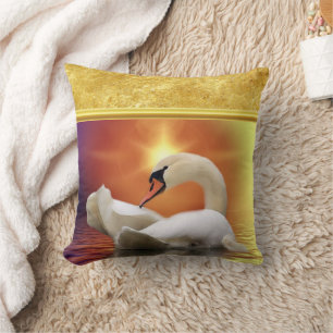 White Swan in a lake with a orange gold sunset Cushion