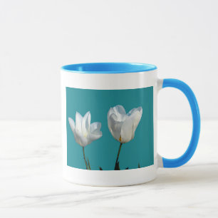 white tulip flowers in aqua blue background mug