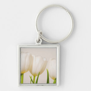 White tulips against a white background, key ring