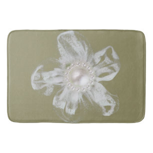 White tulle flower on light taupe bath mat
