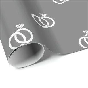 White Wedding Rings on Grey Wrapping Paper