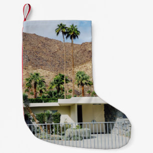 WHITE WOODEN FENCE NEAR GREEN PALM TREE DURING DAY SMALL CHRISTMAS STOCKING
