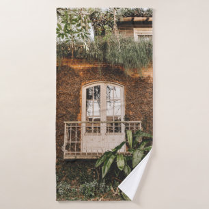 WHITE WOODEN WINDOW FRAME ON BROWN CONCRETE WALL BATH TOWEL