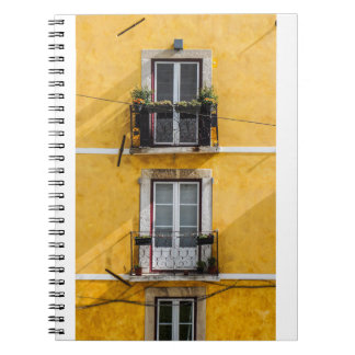WHITE WOODEN WINDOW PANELS AND YELLOW PAINTED WALL NOTEBOOK