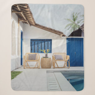 Wicker table and two chairs near swimming pool sherpa blanket