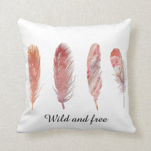 Wild and free pink and peach feathers on white cushion