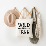 Wild and Free Tote Bag<br><div class="desc">Embrace a bold and adventurous spirit with our custom apparel and gifts featuring a trendy black and white "Wild and Free" typography graphic paired with a stylish boho arrow design. Perfect for free spirits and those who love modern,  minimalist designs,  these items make a great statement for any occasion.</div>