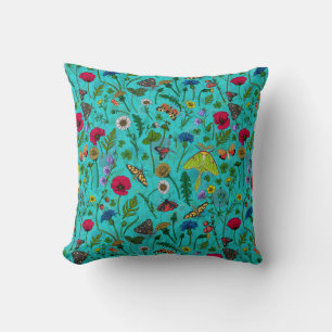 Wild flowers and moths on teal cushion