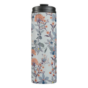 Wild flowers on blue, botanical pattern. thermal tumbler
