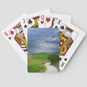 Winding road under a dark sky playing cards