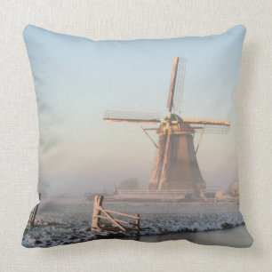 Windmill in the snow at sunrise throw pillow