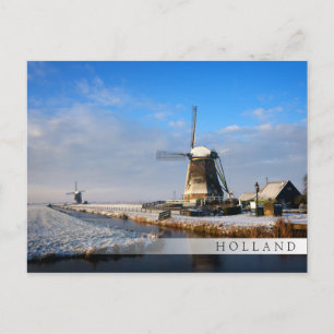 Windmill in the snow in a dutch winter landscape postcard