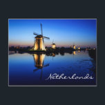 Windmills at Blue Hour in Netherlands postcard<br><div class="desc">Postcard of historic windmills illuminated at dusk during the Blue Hour with reflection in the water in a landscape in Kinderdijk,  the Netherlands with the text: 'Netherlands'.</div>